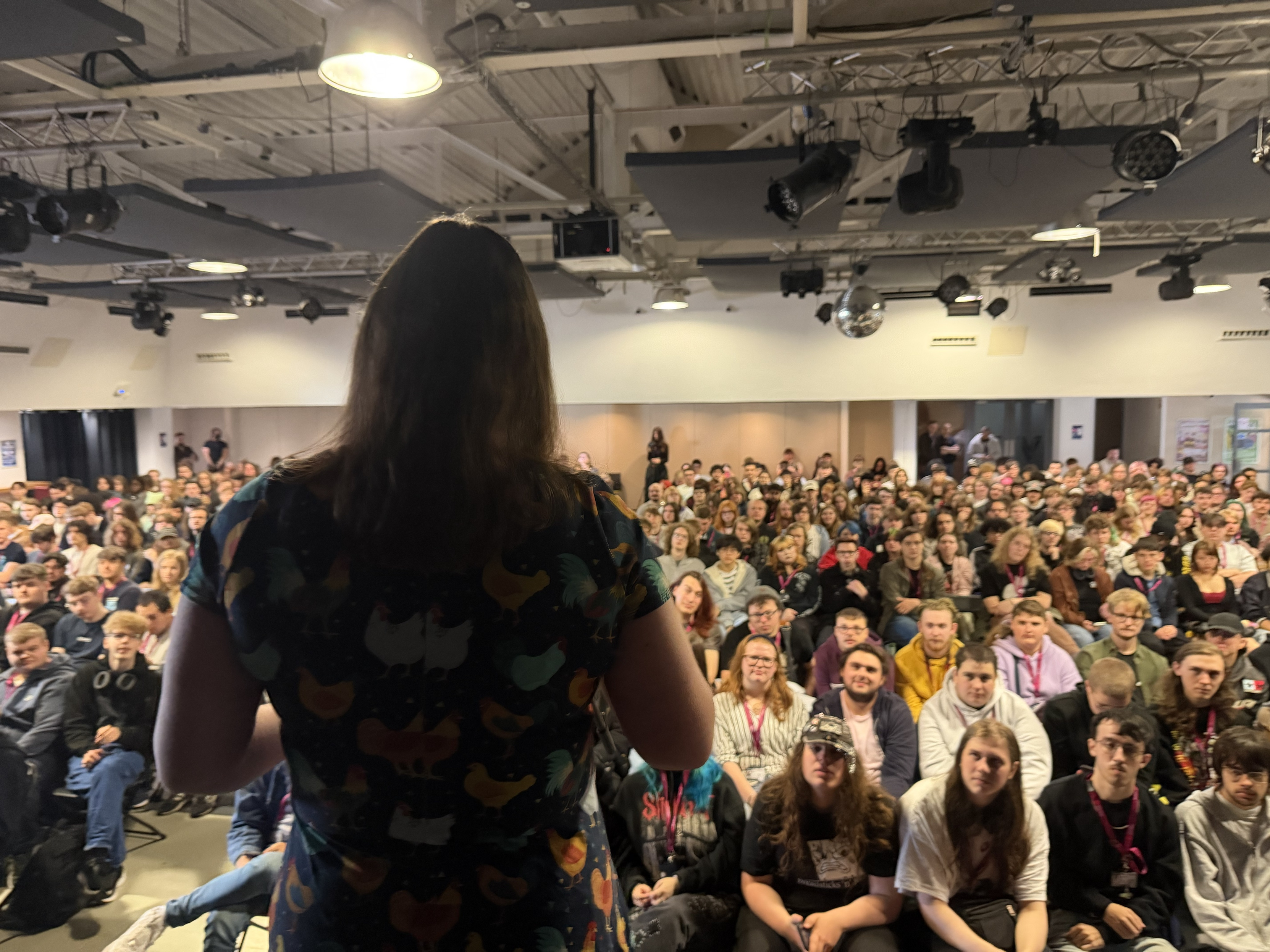 A photo of the back of me, speaking to a large auditorium full of students.
